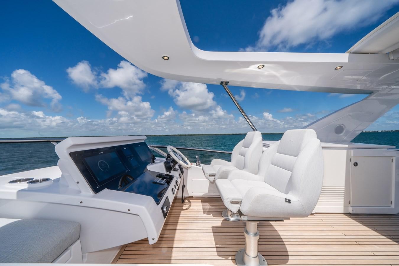 a boat on the water aboard 2022 AZIMUT 72 FLYBRIDGE OUR TRADE Yacht for Sale