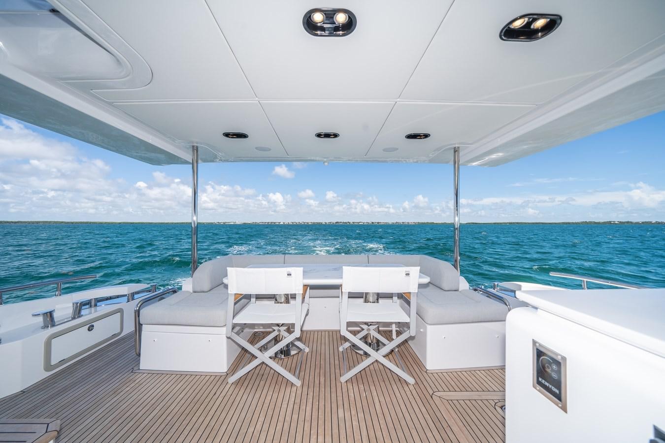 a room with a view of the ocean and a deck aboard 2022 AZIMUT 72 FLYBRIDGE OUR TRADE Yacht for Sale