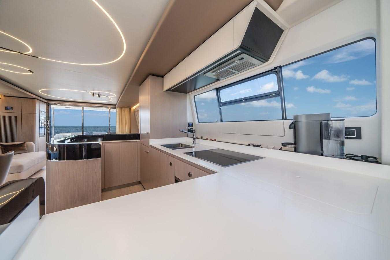 a large kitchen with a large window aboard 2022 AZIMUT 72 FLYBRIDGE OUR TRADE Yacht for Sale