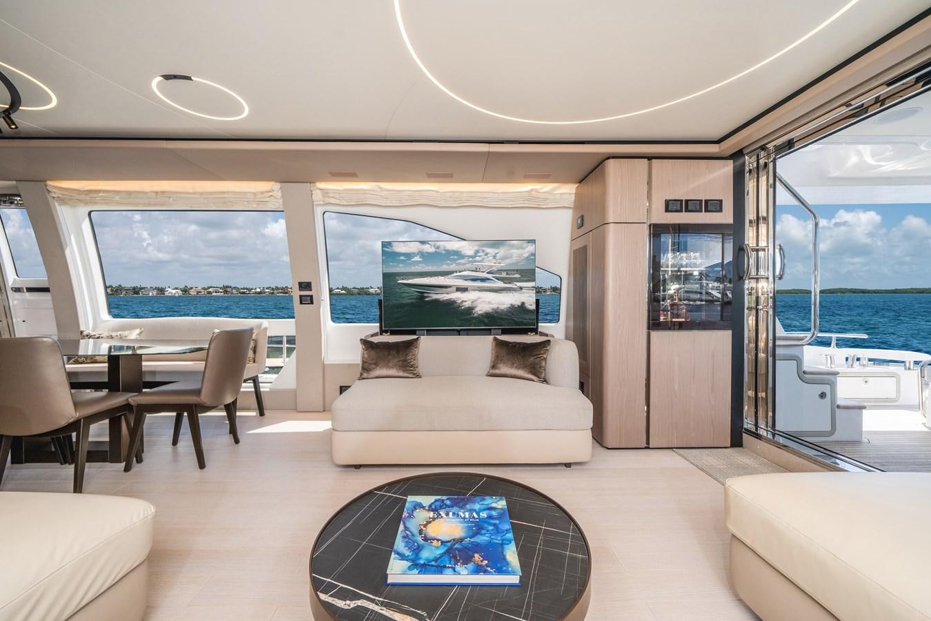 a living room with a large window aboard 2022 AZIMUT 72 FLYBRIDGE OUR TRADE Yacht for Sale