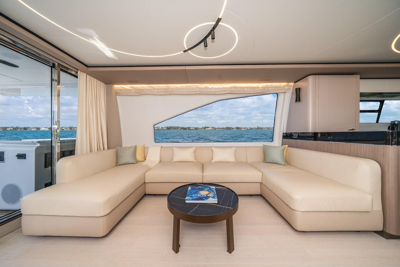 a living room with a couch and a table aboard 2022 AZIMUT 72 FLYBRIDGE OUR TRADE Yacht for Sale