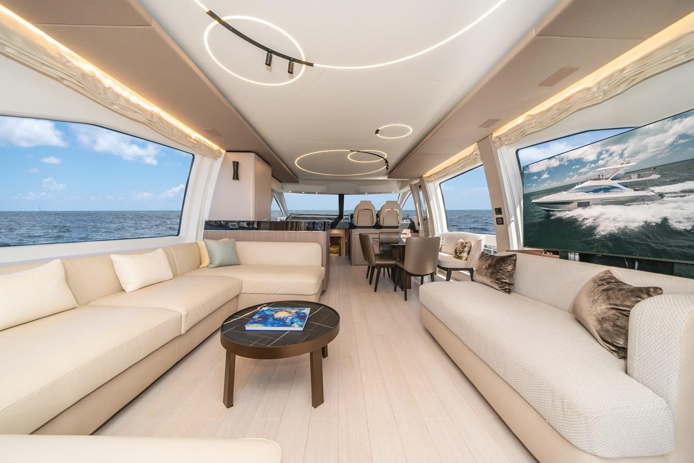 a living room with a large screen aboard 2022 AZIMUT 72 FLYBRIDGE OUR TRADE Yacht for Sale