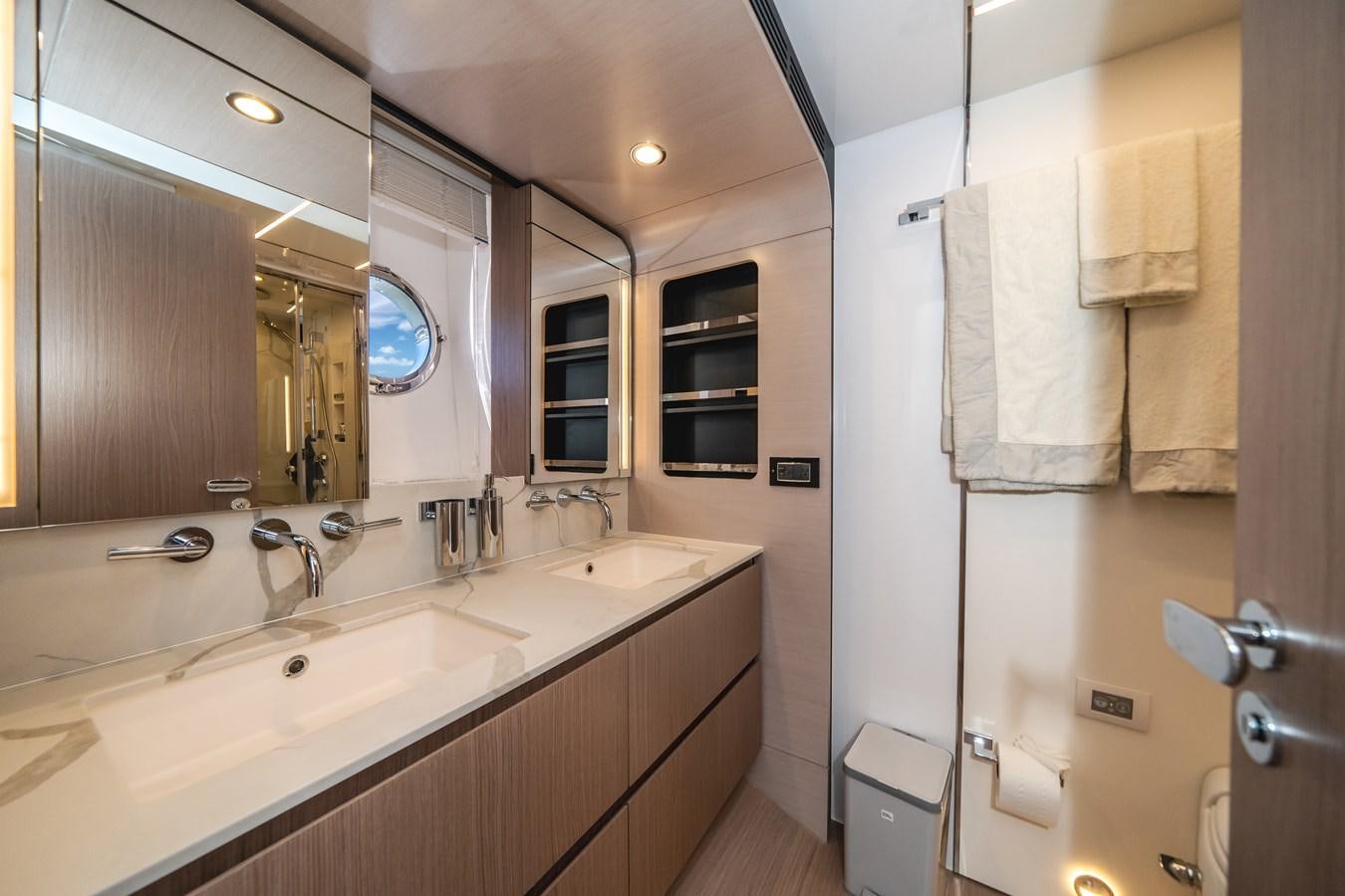 a bathroom with a large mirror aboard 2022 AZIMUT 72 FLYBRIDGE OUR TRADE Yacht for Sale