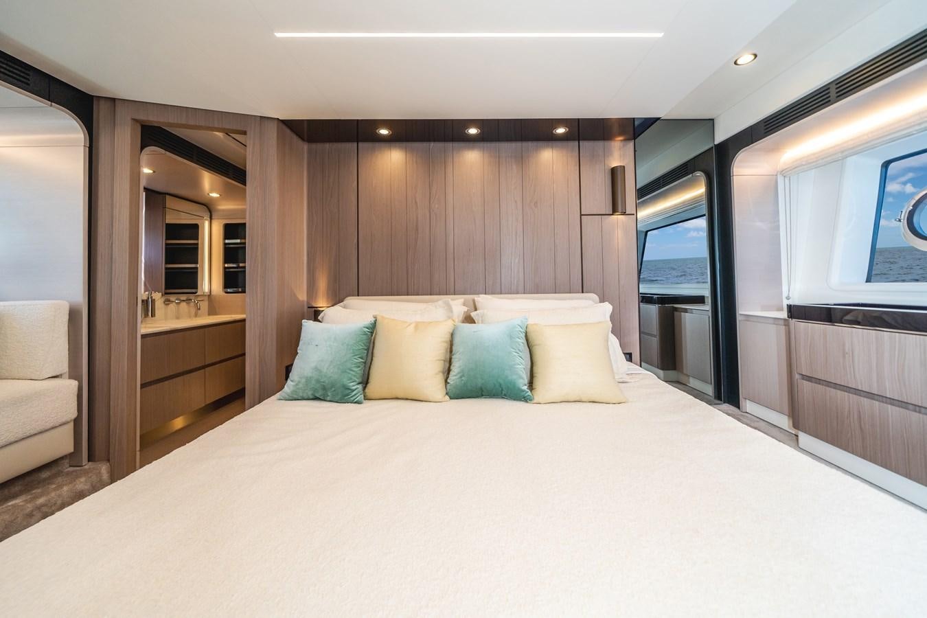 a large bed with pillows aboard 2022 AZIMUT 72 FLYBRIDGE OUR TRADE Yacht for Sale