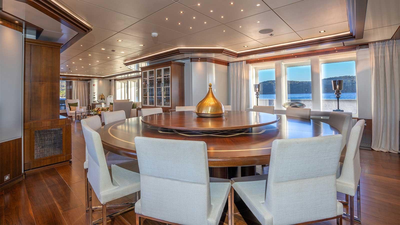 a large dining table in a room aboard IMMERSIVE Yacht for Sale