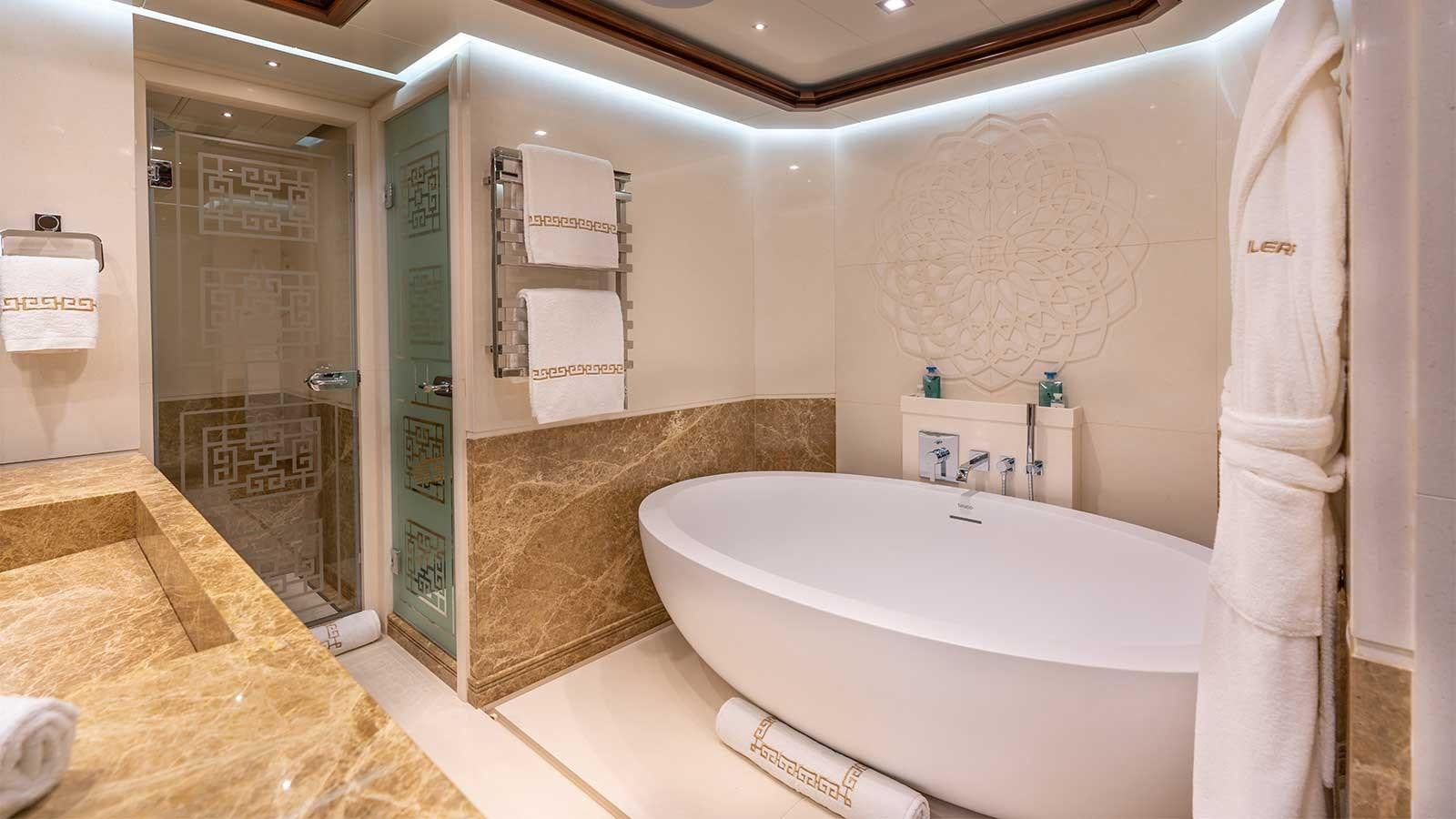 a bathroom with a bathtub and a sink aboard IMMERSIVE Yacht for Sale