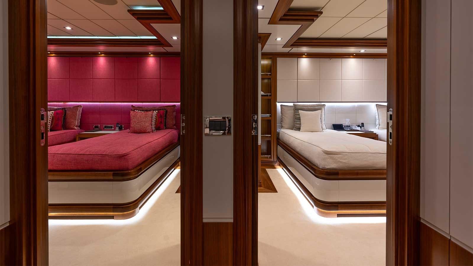 a room with a bed and a mirror aboard IMMERSIVE Yacht for Sale