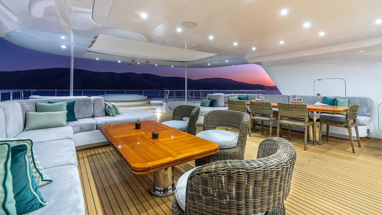 a large room with a table and chairs aboard IMMERSIVE Yacht for Sale