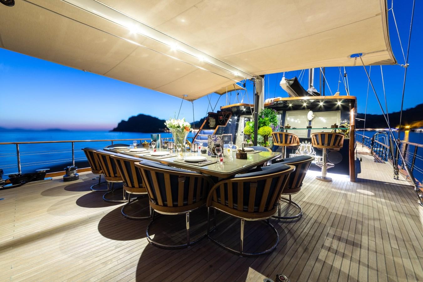 a table set for a dinner party aboard EMANUEL Yacht for Sale