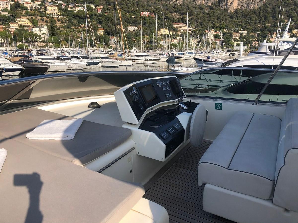 a white car parked in a parking lot with other cars aboard OCEAN DELTA 11 Yacht for Sale