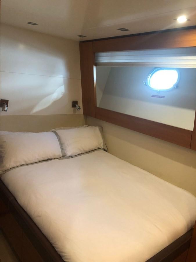 a bed with a white pillow aboard OCEAN DELTA 11 Yacht for Sale