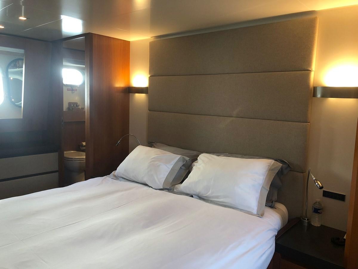 a bed with white pillows aboard OCEAN DELTA 11 Yacht for Sale