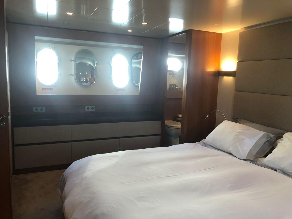 a room with a bed and a television aboard OCEAN DELTA 11 Yacht for Sale