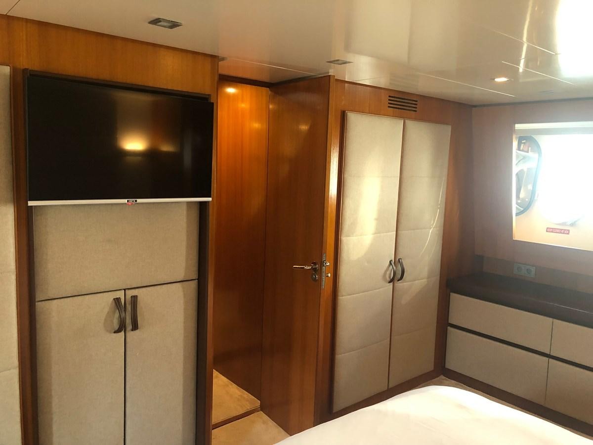 a room with a door and a tv on the wall aboard OCEAN DELTA 11 Yacht for Sale