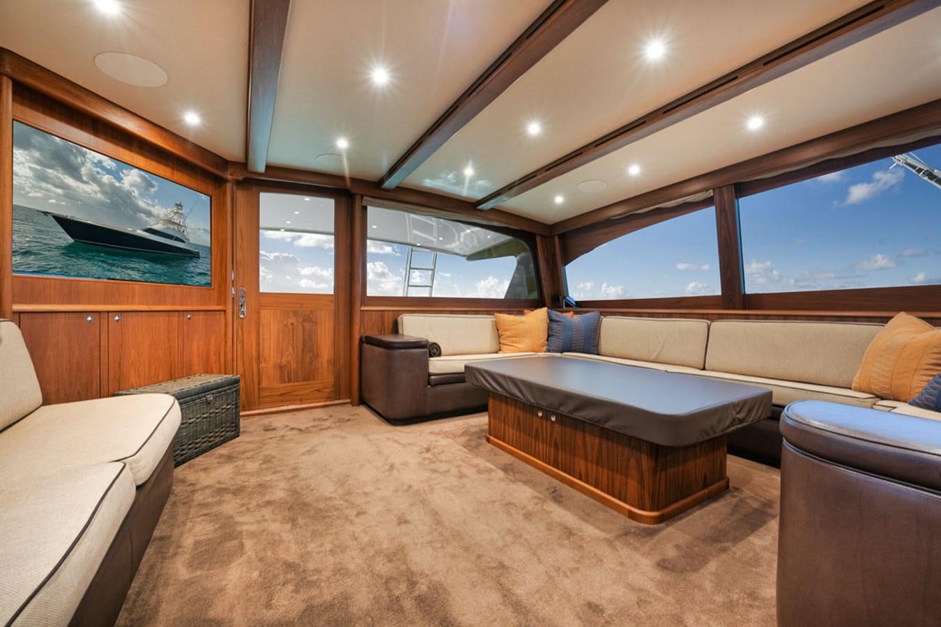 a room with couches and a table aboard OWL'S NEST Yacht for Sale