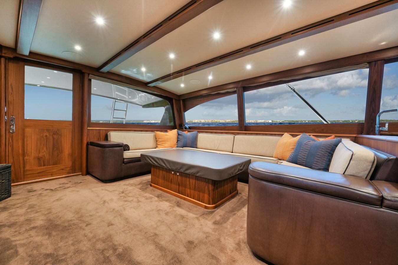 a room with couches and a large window aboard OWL'S NEST Yacht for Sale