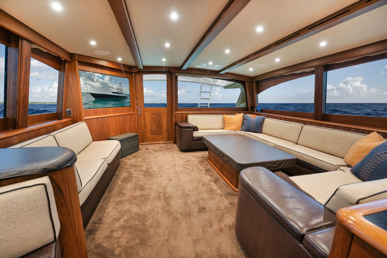a room with a couch and a table aboard OWL'S NEST Yacht for Sale