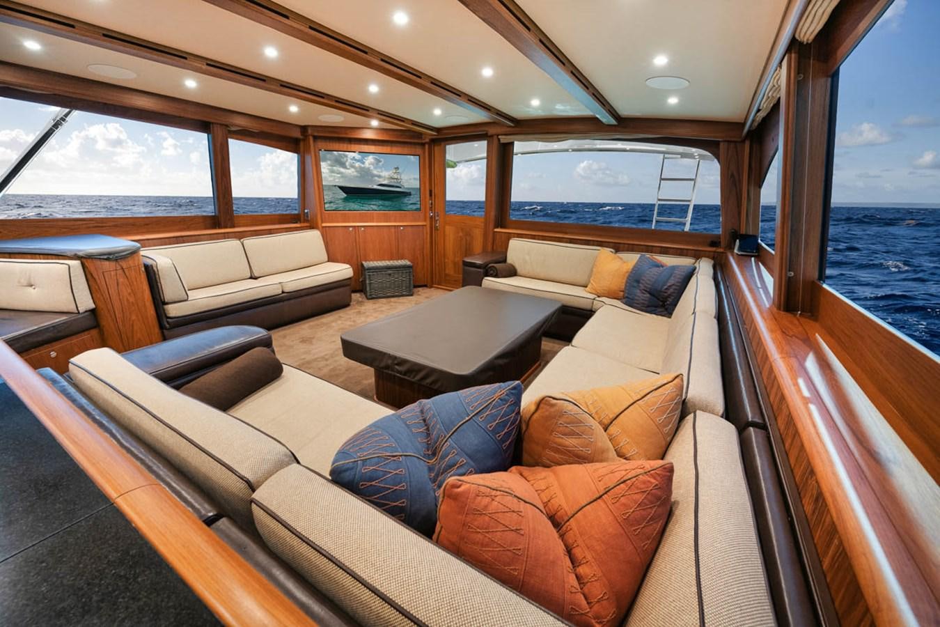 a living room with a couch and a table aboard OWL'S NEST Yacht for Sale