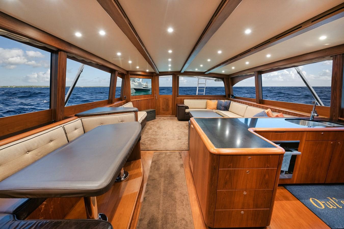 a boat with a table and chairs aboard OWL'S NEST Yacht for Sale