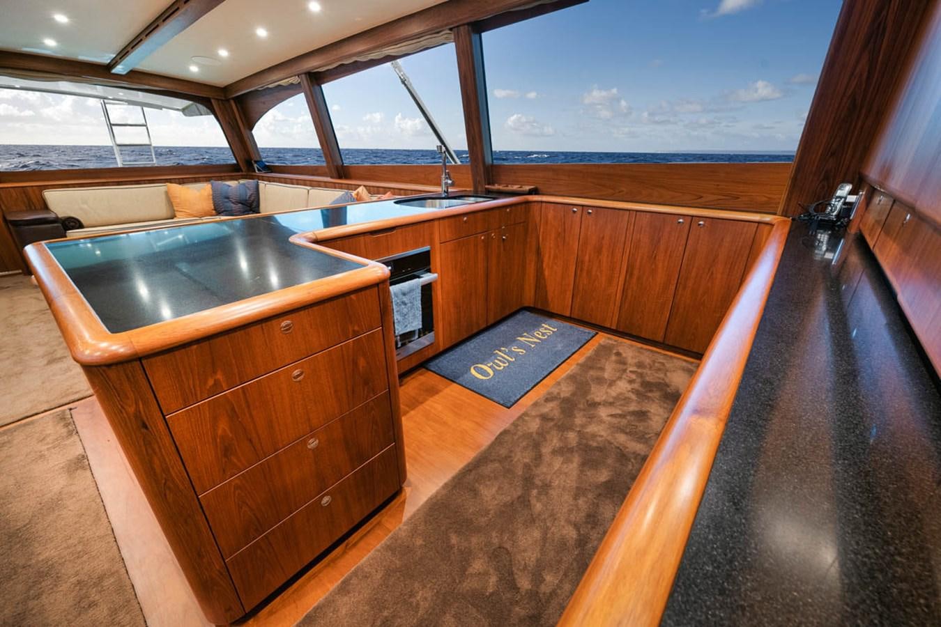 a kitchen with a large island aboard OWL'S NEST Yacht for Sale