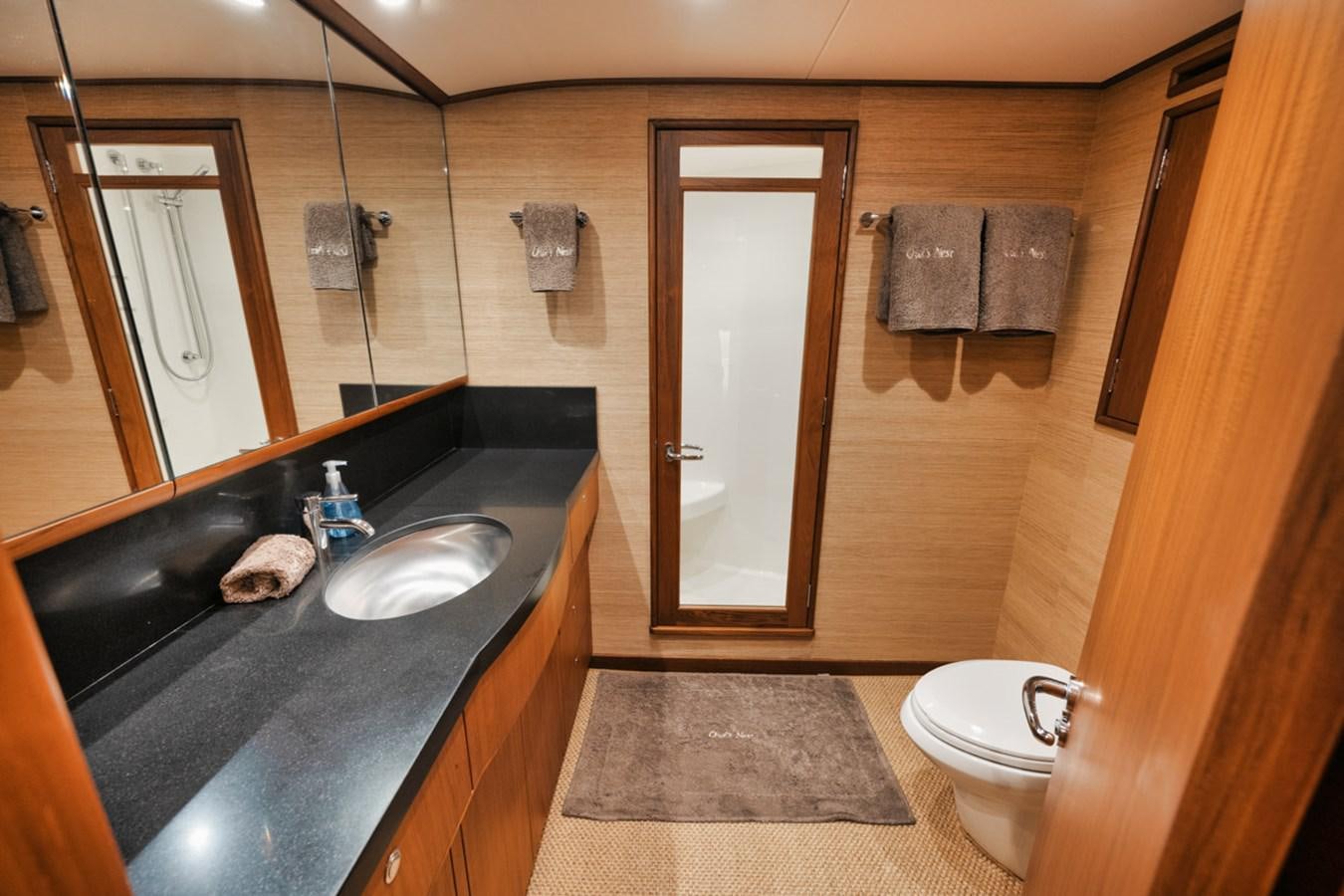 a bathroom with a sink and a toilet aboard OWL'S NEST Yacht for Sale