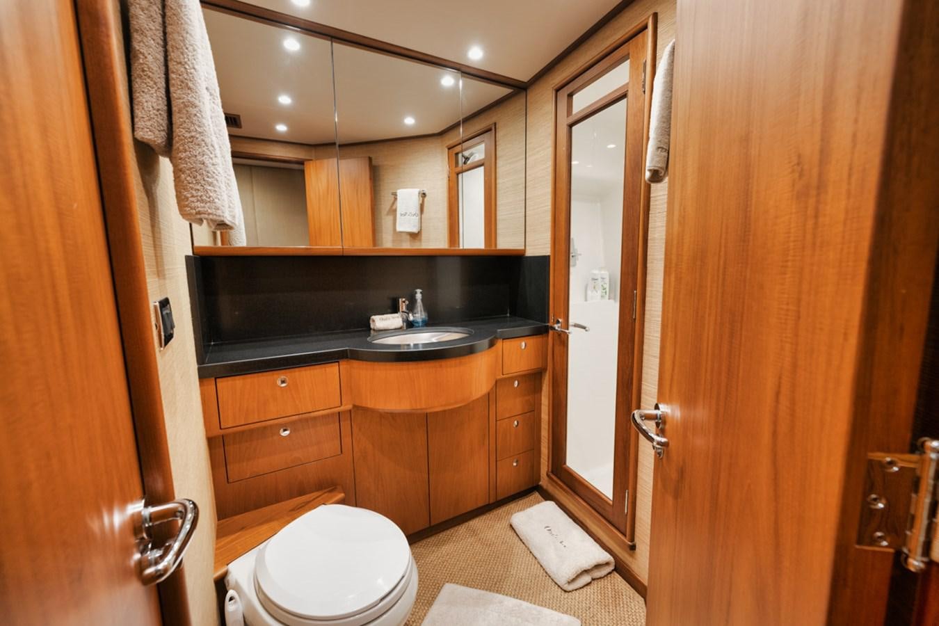 a bathroom with wooden cabinets aboard OWL'S NEST Yacht for Sale