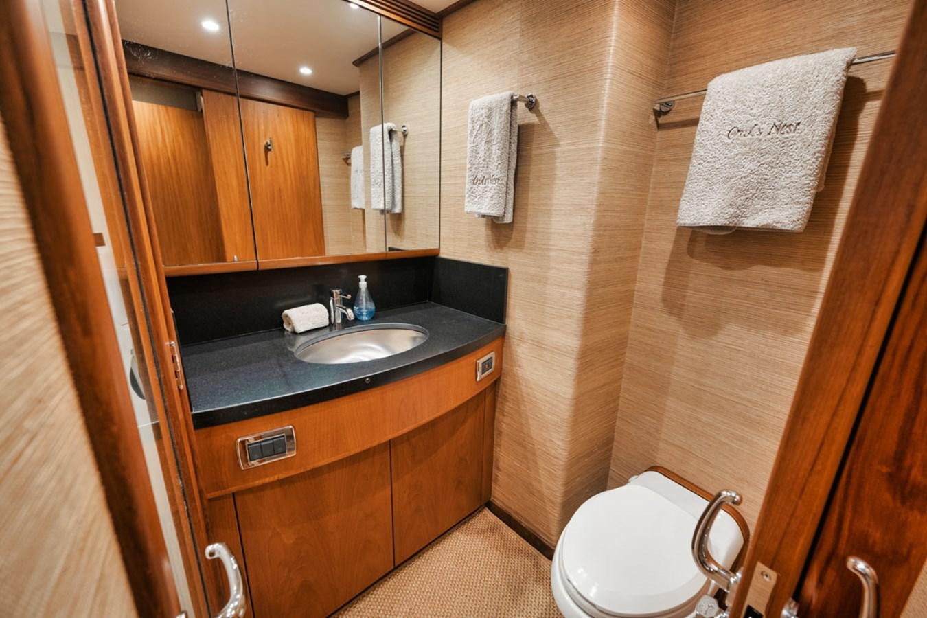 a bathroom with a sink and a toilet aboard OWL'S NEST Yacht for Sale
