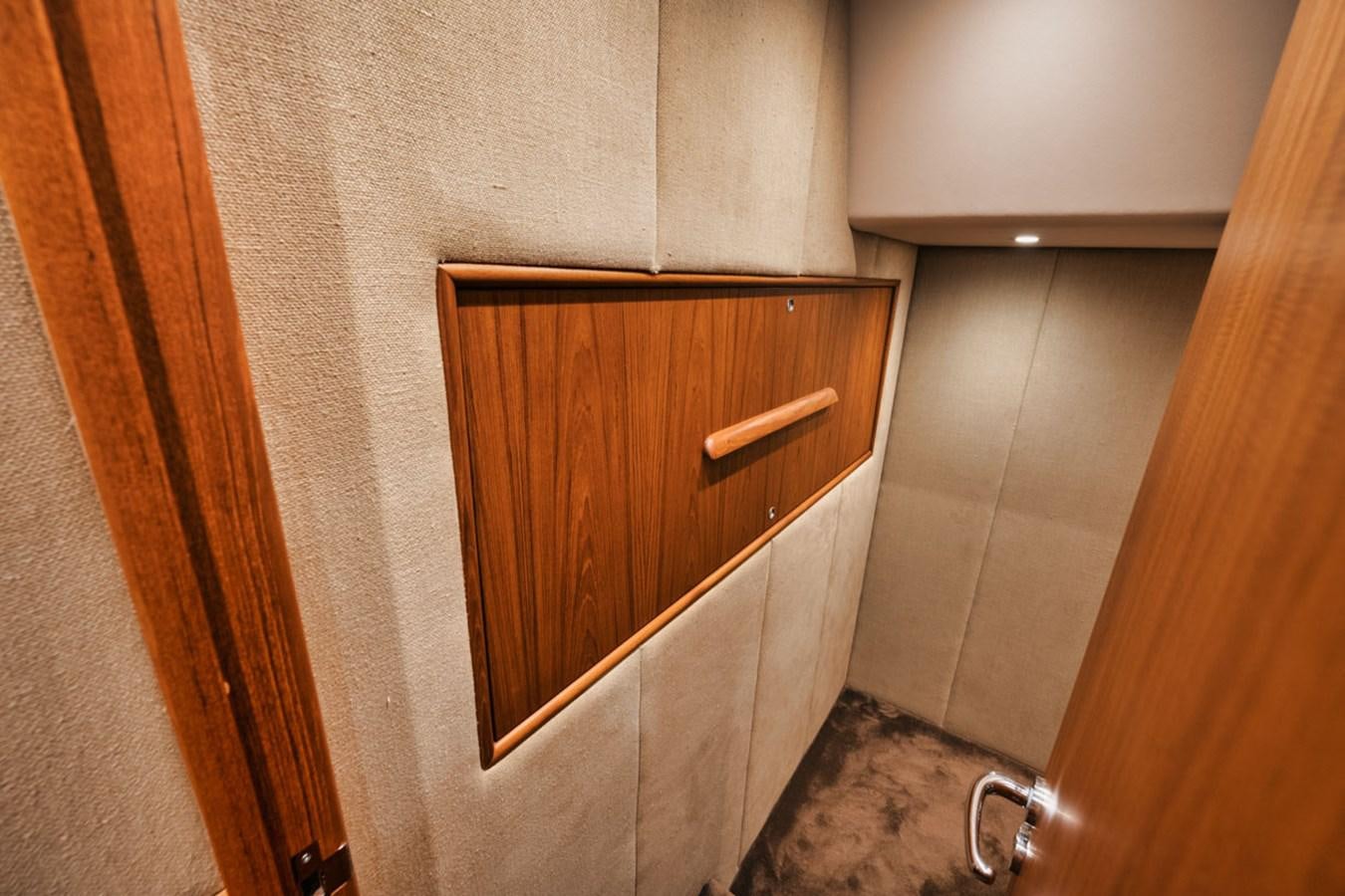 a wooden cabinet in a room aboard OWL'S NEST Yacht for Sale