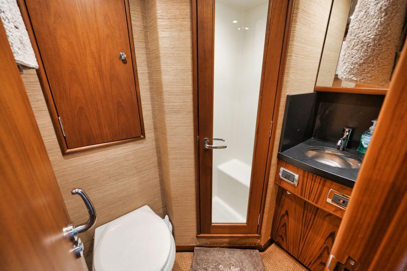 a bathroom with a sink and a toilet aboard OWL'S NEST Yacht for Sale