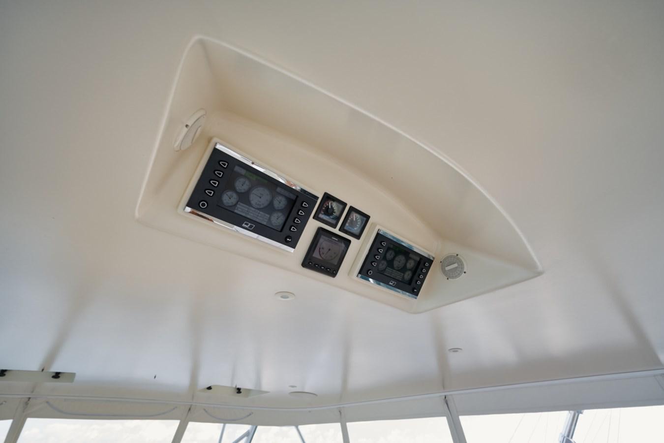 a white wall with a black and silver electronic device on it aboard OWL'S NEST Yacht for Sale