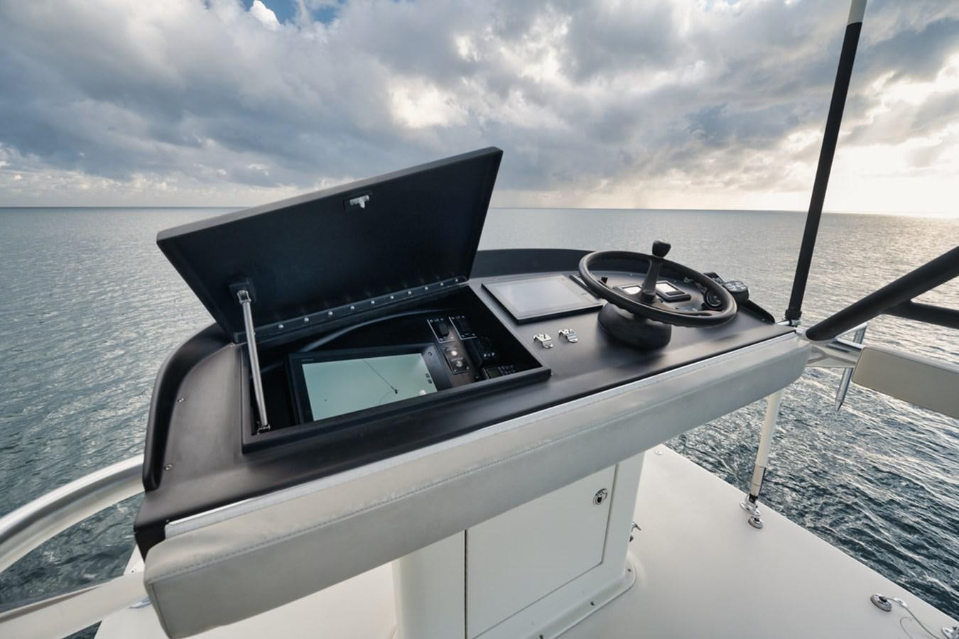 a boat with a steering wheel and a steering wheel on the front aboard OWL'S NEST Yacht for Sale