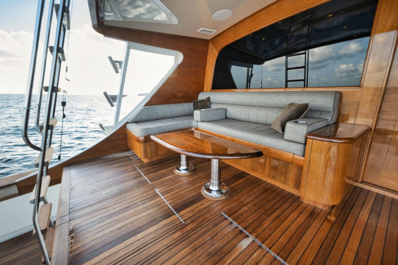 a living room with a couch and a table aboard OWL'S NEST Yacht for Sale
