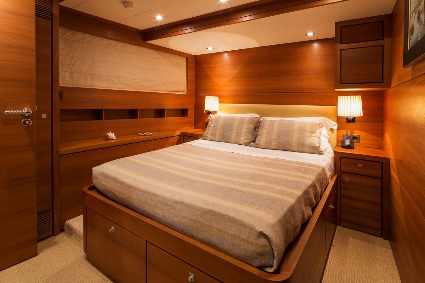 a bed with a white pillow aboard WATER TOY III Yacht for Sale