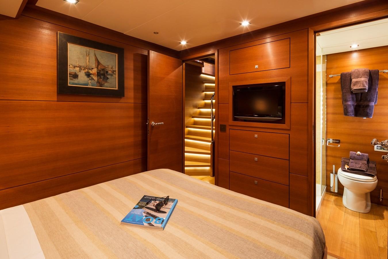 a hotel room with a bed and tv aboard WATER TOY III Yacht for Sale