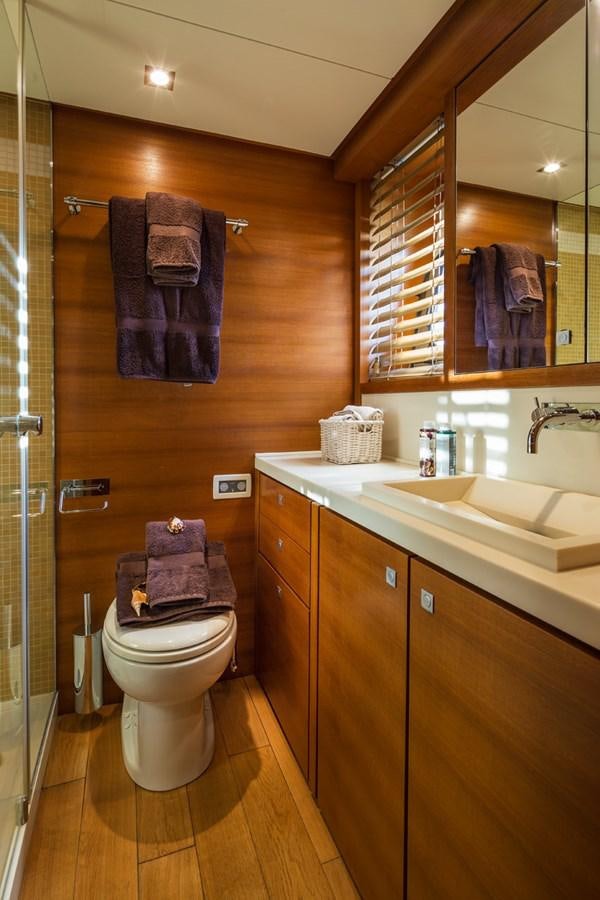 a bathroom with a toilet and a sink aboard WATER TOY III Yacht for Sale