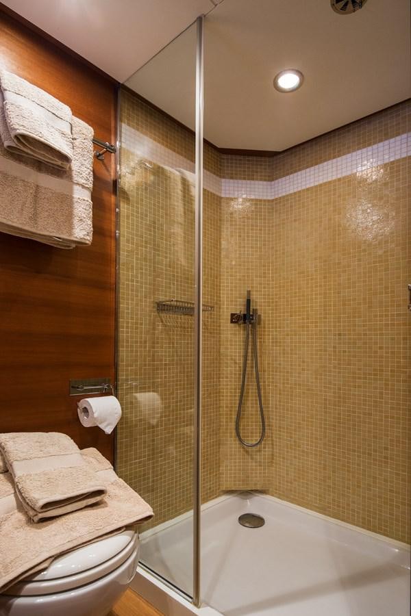 a bathroom with a shower unit and toilet aboard WATER TOY III Yacht for Sale