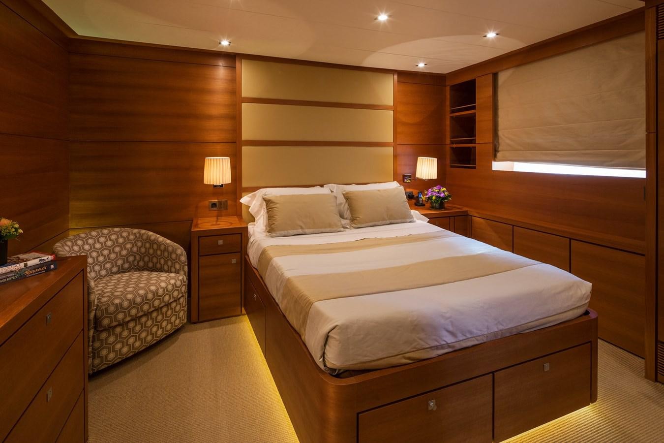 a room with a bed and a chair aboard WATER TOY III Yacht for Sale