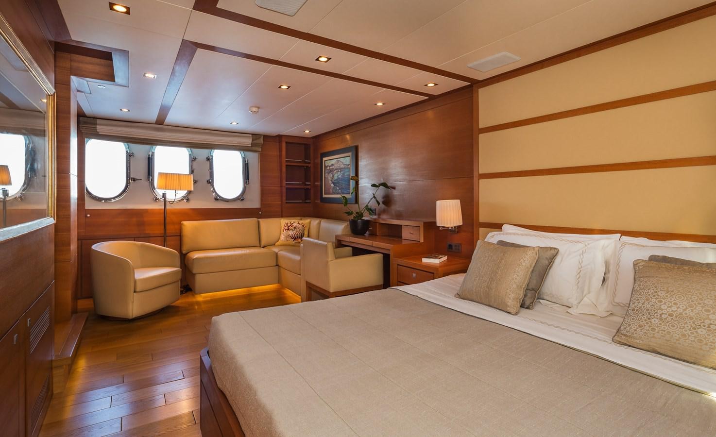 a large bedroom with a bed and a desk aboard WATER TOY III Yacht for Sale