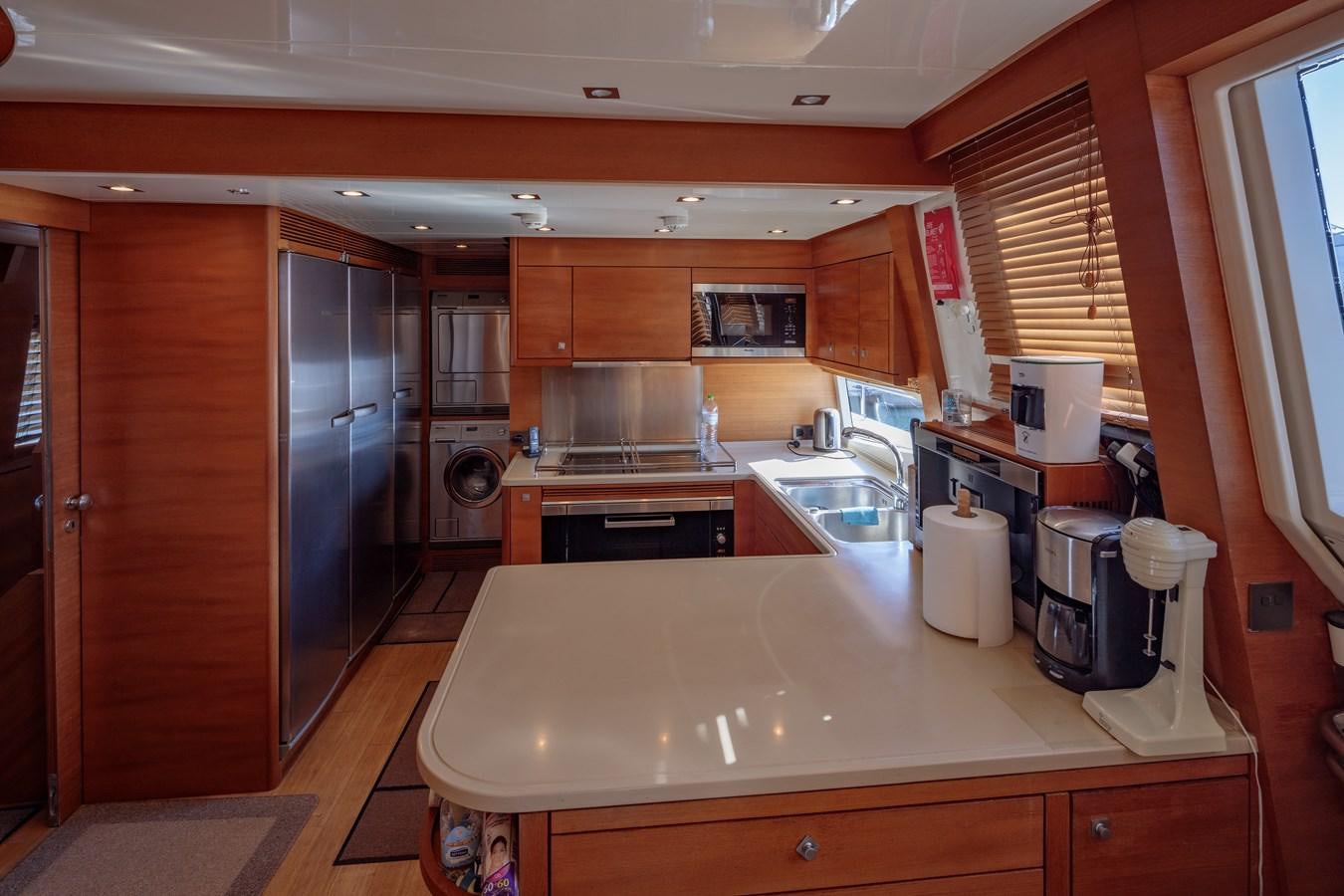 a kitchen with wooden cabinets aboard WATER TOY III Yacht for Sale