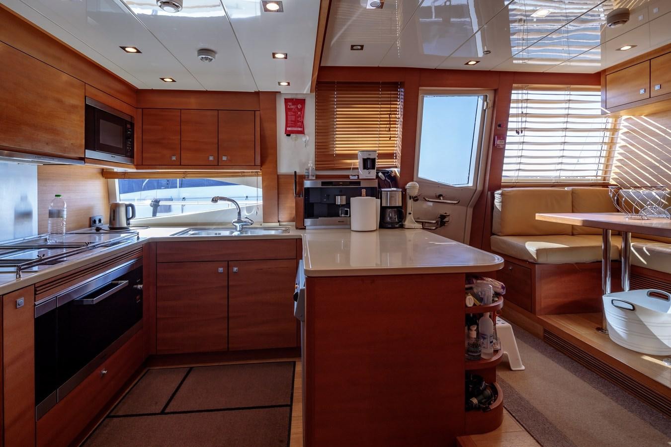 a kitchen with wooden cabinets aboard WATER TOY III Yacht for Sale