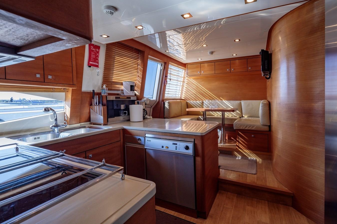 a kitchen with wooden cabinets aboard WATER TOY III Yacht for Sale