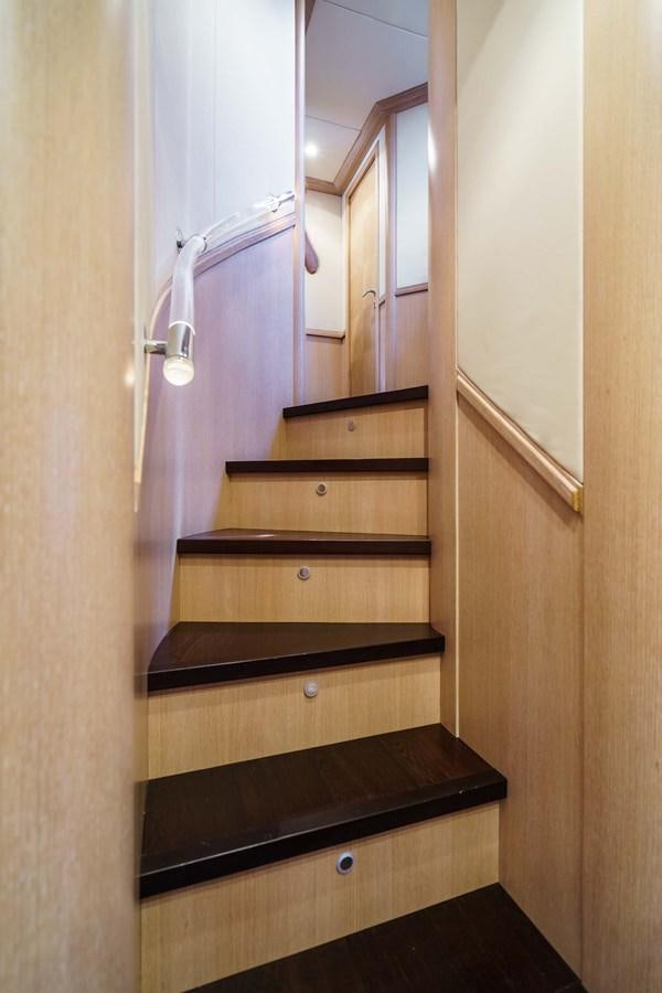 a wooden staircase with a light on aboard ALLIE Yacht for Sale