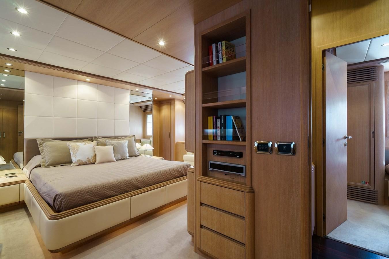 a bedroom with a bed and a bookcase aboard ALLIE Yacht for Sale