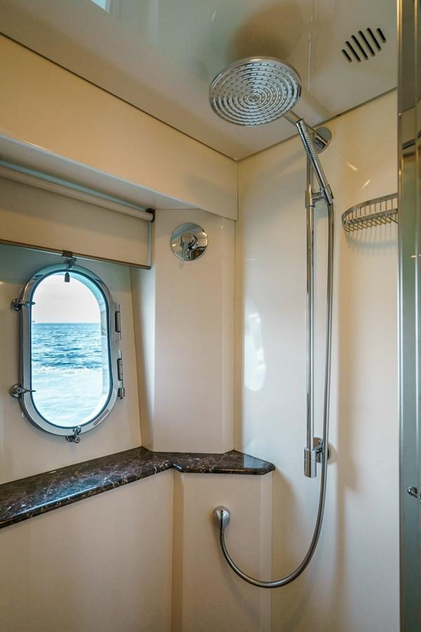 a bathroom with a shower and a mirror aboard ALLIE Yacht for Sale