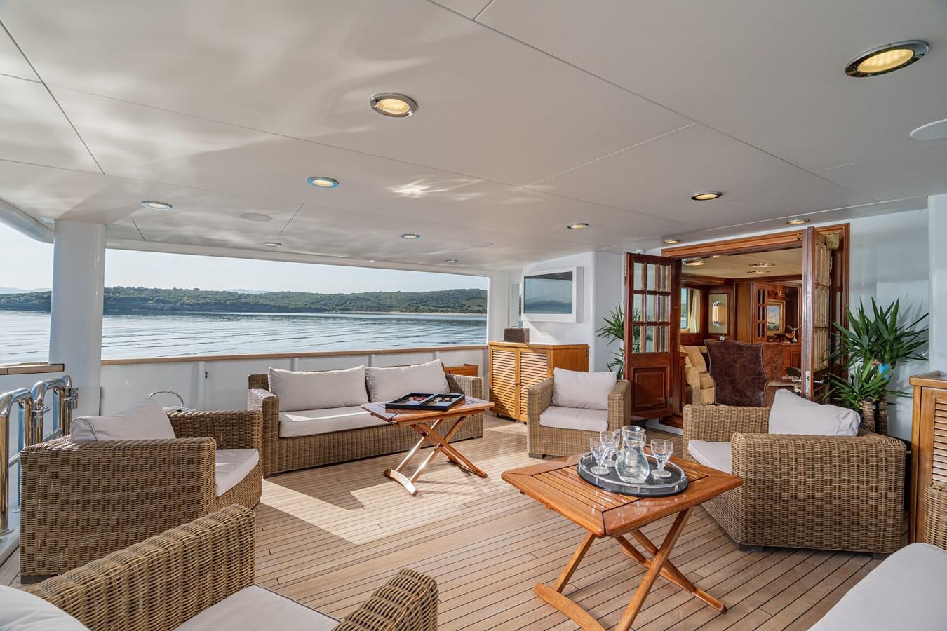 a living room with a large ocean aboard AQUARIUS IV Yacht for Sale