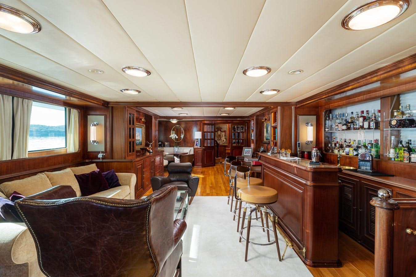a living room with a couch and a coffee table aboard AQUARIUS IV Yacht for Sale