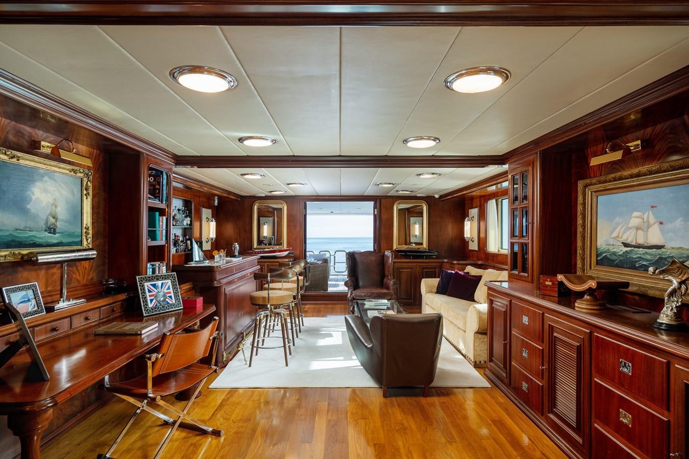 a living room with a wood floor aboard AQUARIUS IV Yacht for Sale