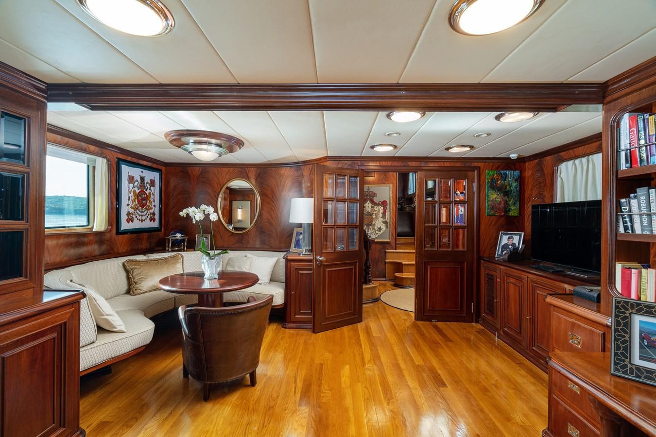 a living room with a wood floor aboard AQUARIUS IV Yacht for Sale