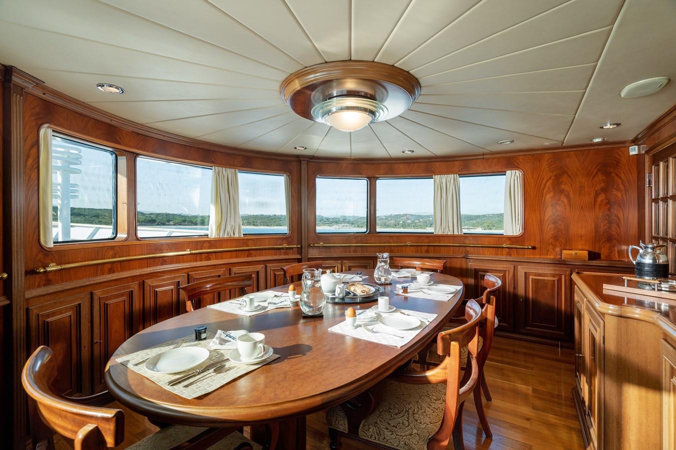 a kitchen with a dining table aboard AQUARIUS IV Yacht for Sale