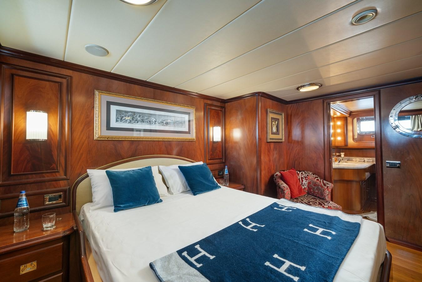 a room with a bed and a mirror aboard AQUARIUS IV Yacht for Sale